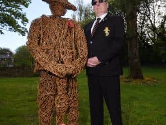 Peter Powell, treasurer of Atherton Cenotaph Memorial Project, stands next to a wicker statue
