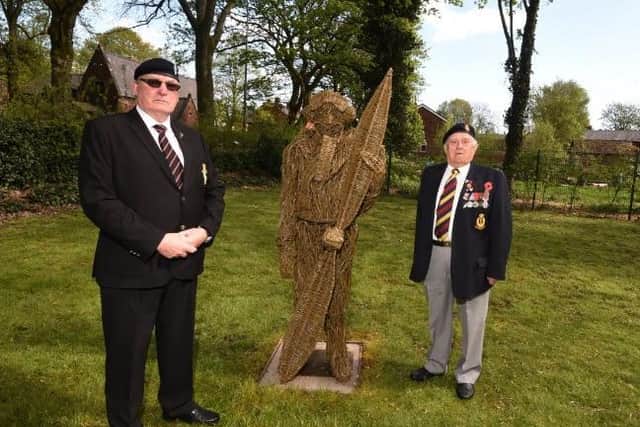 From left, Peter Powell and Bob Spaine, members of Atherton Cenotaph Memorial Project, stand next to another wicker statue