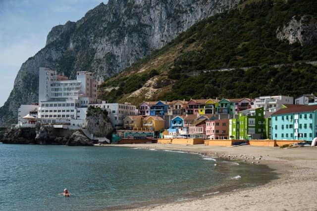 A man swims in Catalan Bay beach in Gibraltar