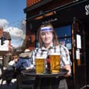 Kayleigh Bamber serving a round of drinks at Sherringtons