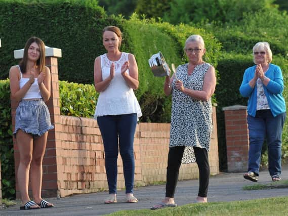 Residents on Winstanley Road, Pemberton, taking part in the clap for carers during the first national lockdown