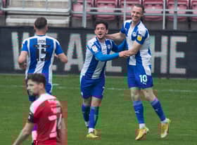 Zach Clough celebrates scoring the fourth of seven goals at the DW