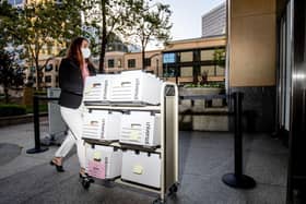 A member of the Epic Games legal team rolls a cart with documents while entering federal court on May 4, 2021 in Oakland, California.