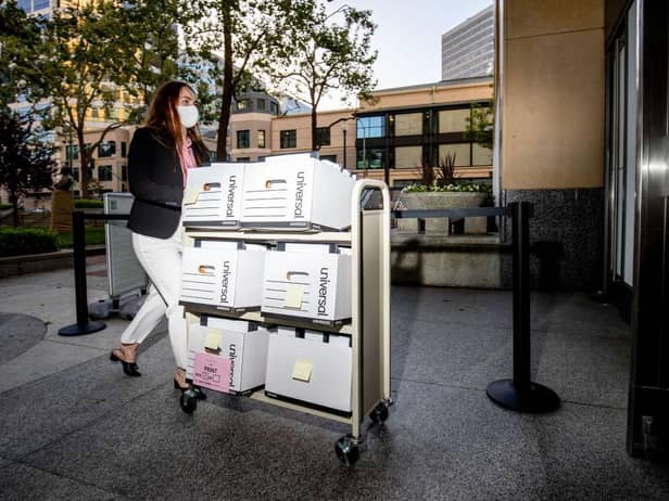 A member of the Epic Games legal team rolls a cart with documents while entering federal court on May 4, 2021 in Oakland, California.