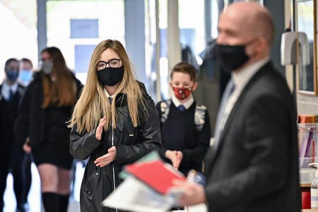 Secondary school pupils in England will no longer be required to wear face masks in class from next week