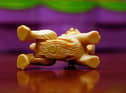A 1/8-inch magnet is shown attached to the underside of a dog from the Polly Pocket toy series
