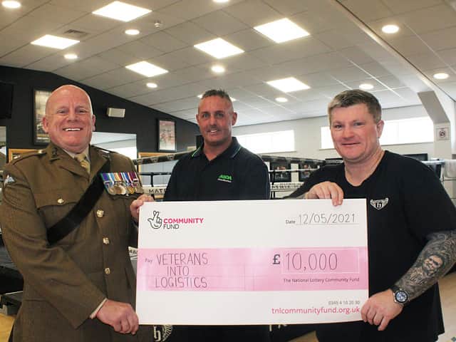Ricky Hatton, right, presents the cheque to Wiganer Steve Eden and Major Ian Battersby, chairman of Veterans Into Logistics