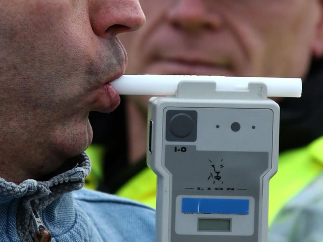 A drunken man drove at high speed around a village green with a flashing blue light in the window of his car