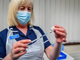 A nurse preparing a dose of a Covid-19 vaccine