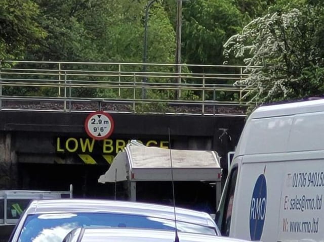 The van stuck beneath the low bridge on Prescott Street