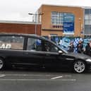 The hearse going past Westfield Community School on Montrose Avenue