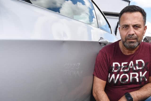 Huseyin Yalcin Kaya with his damaged car