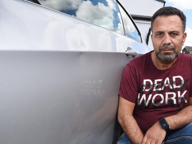 Huseyin Yalcin Kaya with his damaged car