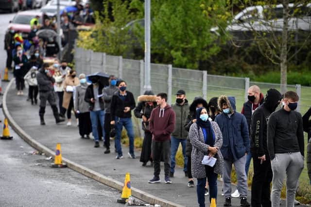 A queue of people waiting to get the coronavirus vaccination in Bolton