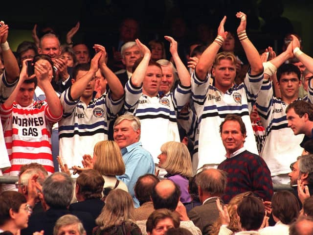 The Wigan team who had already changed shirsts with the Bath  players applaud  the fans