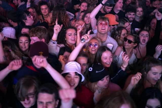 Concert-goers enjoy a non-socially distanced outdoor live music event at Sefton Park on May 2, 2021 in Liverpool.