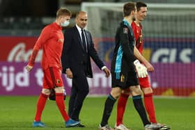 Roberto Martinez engaged in conversation with Kevin de Bruyne