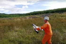 A surveyor launching a drone