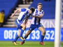 Will Grigg celebrates his winning goal against Manchester City in the FA Cup with Max Power