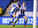 Will Grigg celebrates his winning goal against Manchester City in the FA Cup with Max Power