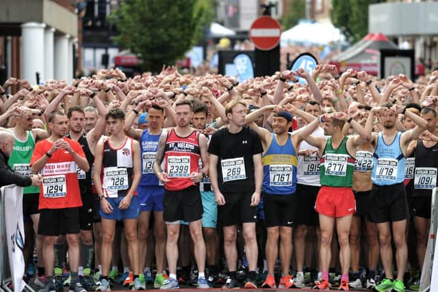 Runners do the Joining Jack salute at the start of the Wigan 10k in 2019