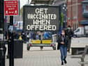 People shop and go about their daily life in Bolton town centre as surge testing and rapid coronavirus vaccinations continue.