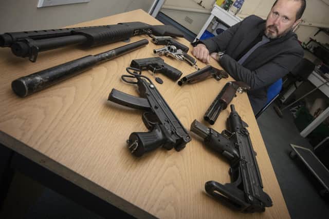 Det Insp Simon Akker with some of the weapons recovered