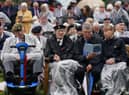 Veterans watch the official opening of the British Normandy Memorial in France via a live feed during a ceremony at the National Memorial Arboretum in Alrewas, Staffordshire
