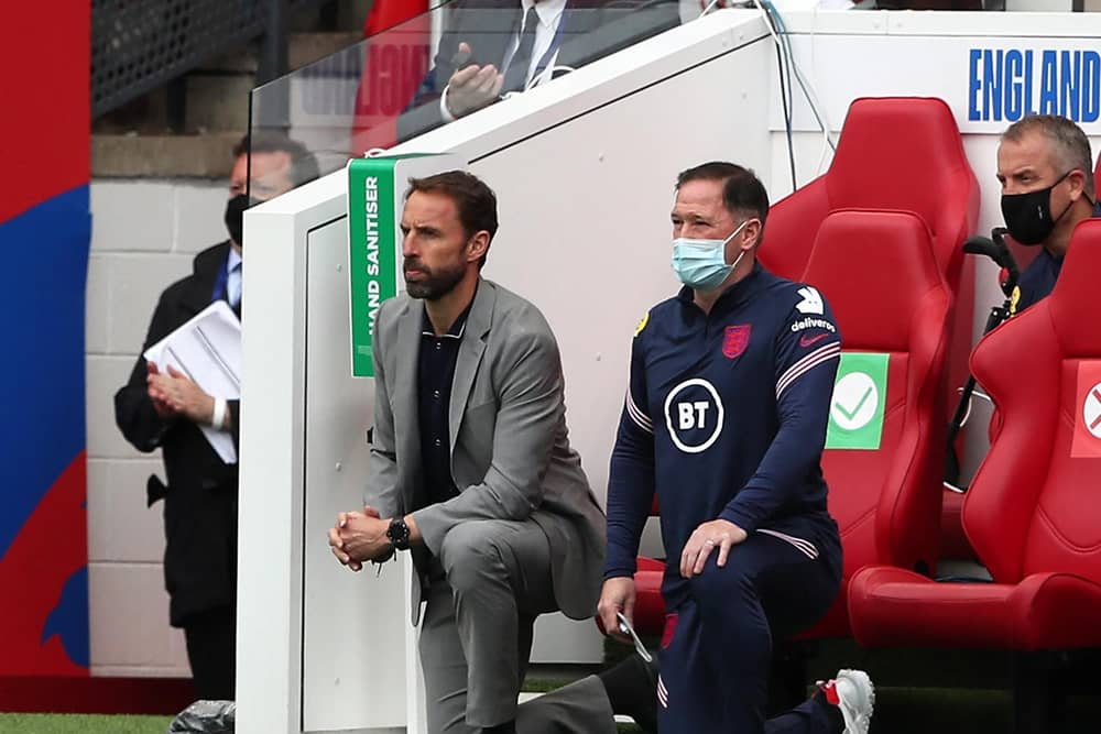 England's manager Gareth Southgate (L) and Steve Holland, Assistant Coach of England (R) 'take a knee' ahead of the international friendly football match between England and Romania at the Riverside Stadium in Middlesbrough.