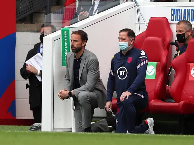 England's manager Gareth Southgate (L) and Steve Holland, Assistant Coach of England (R) 'take a knee' ahead of the international friendly football match between England and Romania at the Riverside Stadium in Middlesbrough.