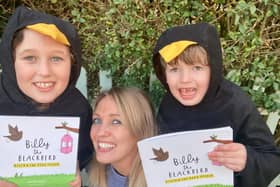 Jennifer Doyle with daughter Isabella and son Harry, holding up the Billy the Blackbird book