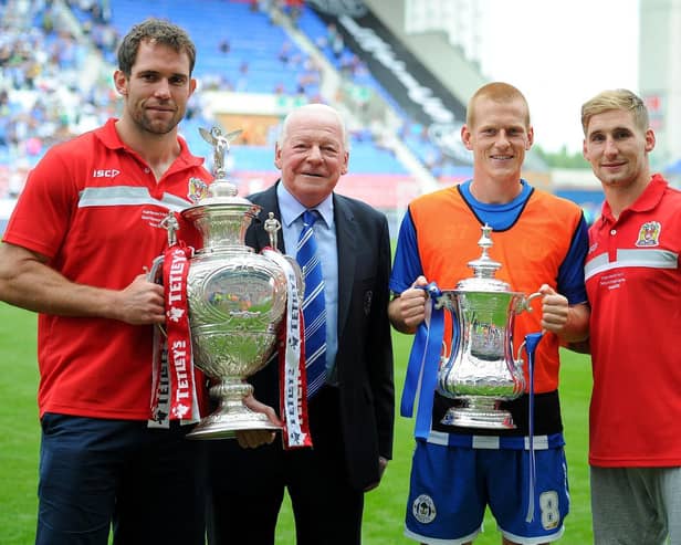 Pat Richards on the pitch at the DW Stadium the day after winning the 2013 Challenge Cup, with Latics chairman Dave Whelan, FA Cup hero Ben Watson and Sam Tomkins
