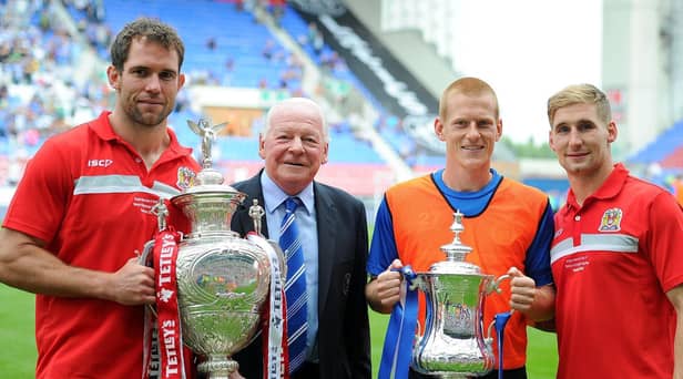 Pat Richards on the pitch at the DW Stadium the day after winning the 2013 Challenge Cup, with Latics chairman Dave Whelan, FA Cup hero Ben Watson and Sam Tomkins