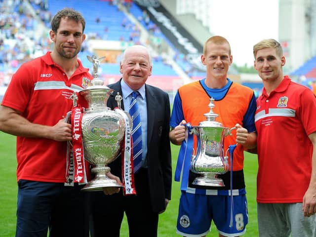 Pat Richards on the pitch at the DW Stadium the day after winning the 2013 Challenge Cup, with Latics chairman Dave Whelan, FA Cup hero Ben Watson and Sam Tomkins