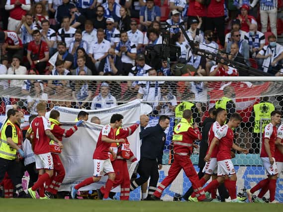 Christian Eriksen is helped from the pitch