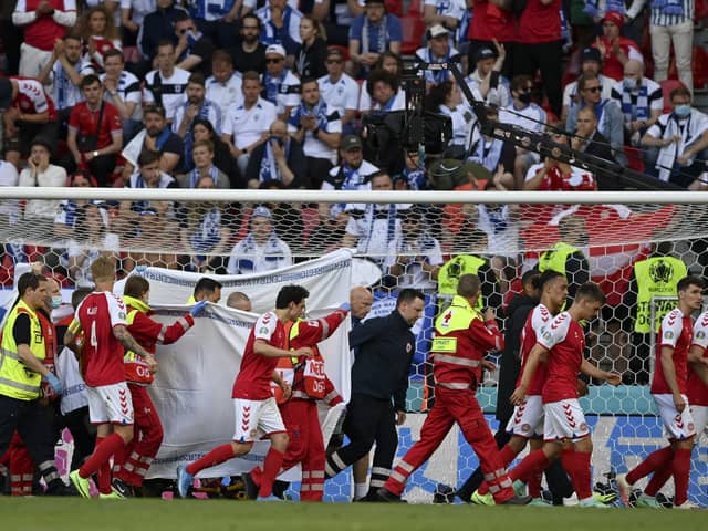 Christian Eriksen is helped from the pitch