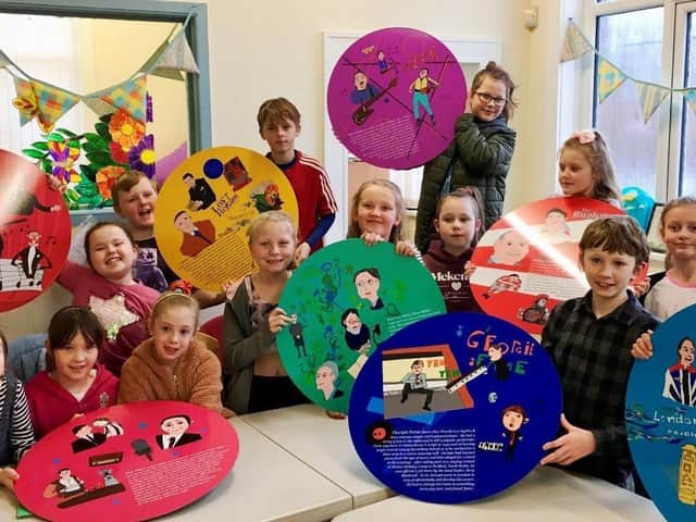 Pupils from Sacred Heart Catholic Primary School with some of the plaques