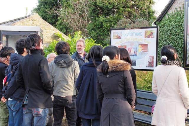 Bruce Crowther pictured showing a group of young visitors from Japan around Garstang, the world's first Fair Trade town.