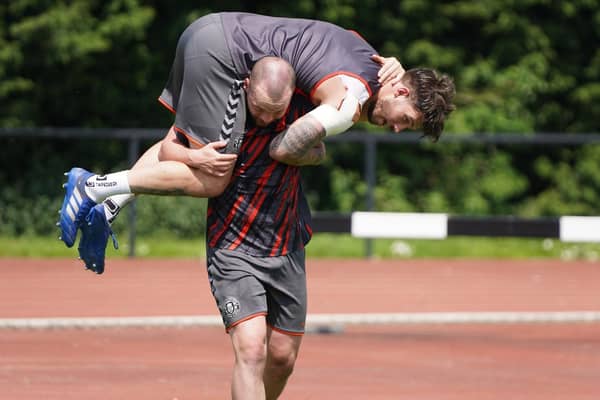 Liam Marshall carries Oliver Gildart in training