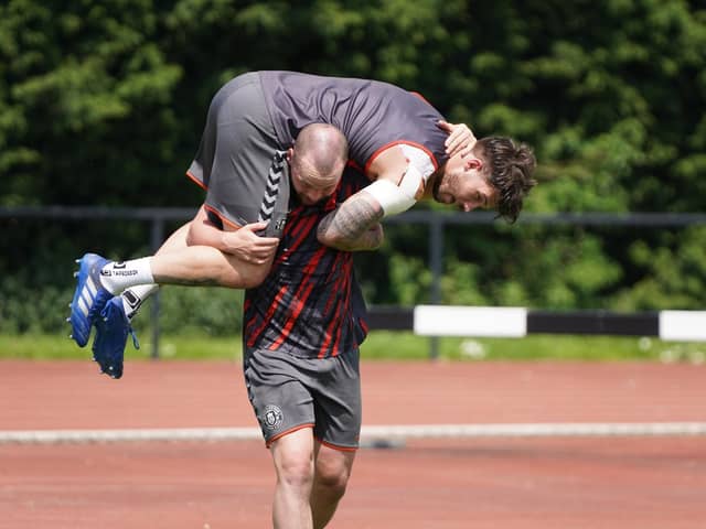 Liam Marshall carries Oliver Gildart in training