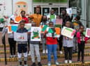 Artist Ibukun Baldwin with young people and their art for the exhibition
