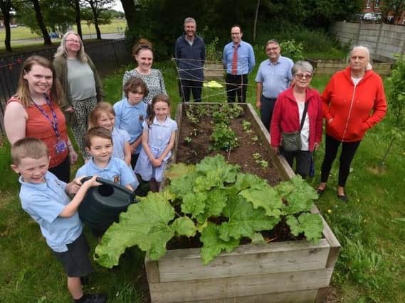 Members of the community join in the ‘Get Aspull Growing’ project at the Incredible Edible garden