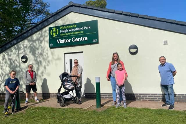 Coun Chris Ready (far right) with Coun Ron Conway and Coun Laura Flynn and a mum with a pram outside Haigh Woodland Park visitor centre