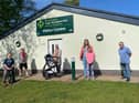 Coun Chris Ready (far right) with Coun Ron Conway and Coun Laura Flynn and a mum with a pram outside Haigh Woodland Park visitor centre