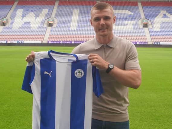 Max Power modelling the new/old Latics home shirt