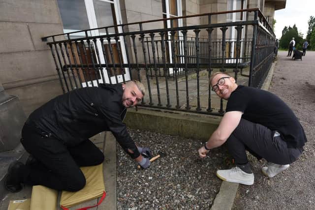 Artist Al Taylor and James Winterbottom, from Wigan Council, get stuck in