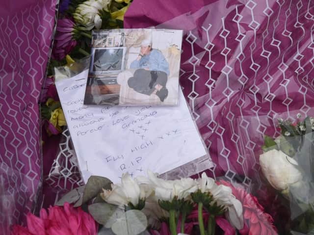 Flowers left at the scene of the fire in St James Grove, Poolstock