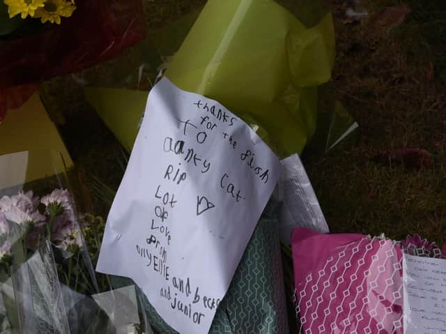 Flowers left at the scene of the fire in St James Grove, Poolstock