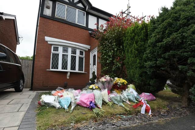 Flowers left at the scene of the fire in St James Grove, Poolstock