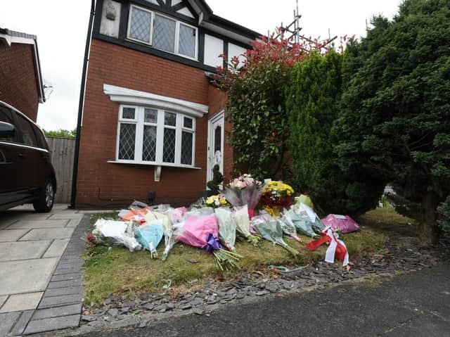 Flowers left at the scene of the fire in St James Grove, Poolstock